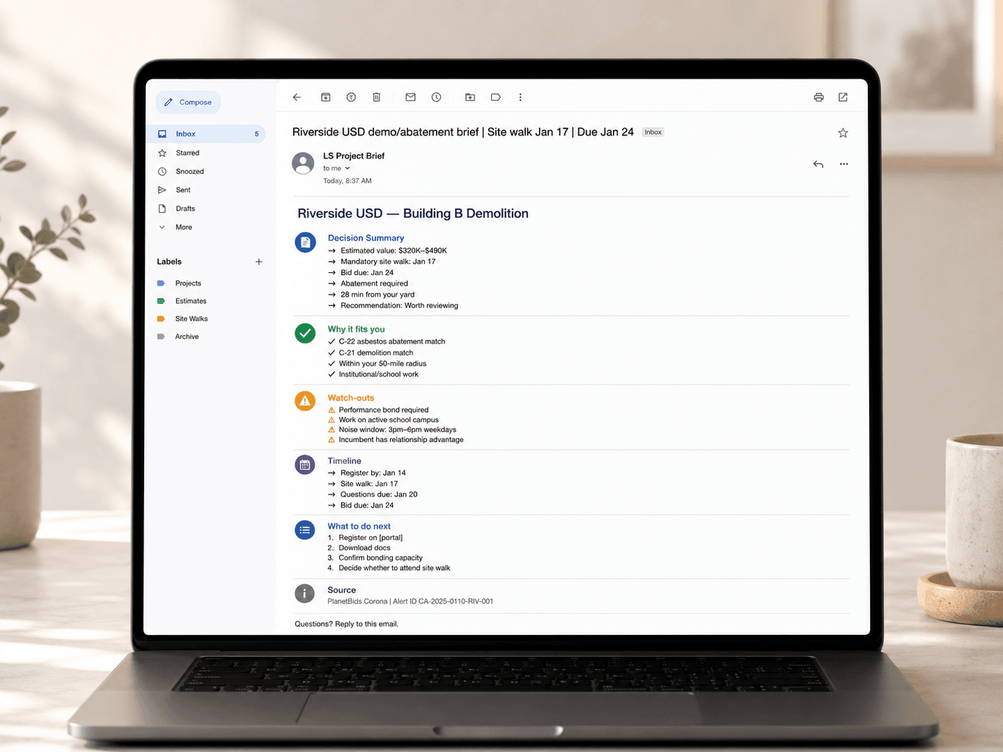 Laptop showing a full Project Brief email sample.